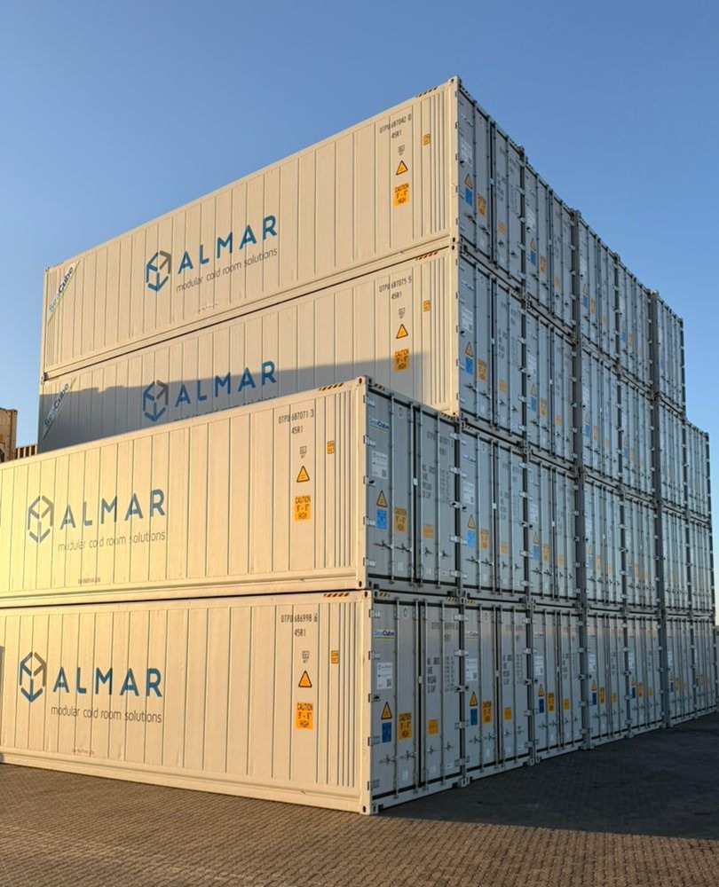 Stacked refrigerated shipping containers at an Almar Namibia depot, ready for rental and temperature-controlled storage.