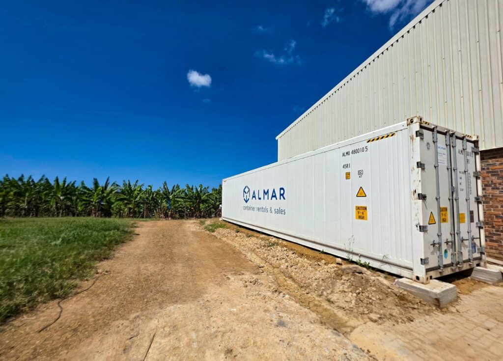 An Almar refrigerated container positioned on a gravel pad next to a large warehouse at Stegen Group.